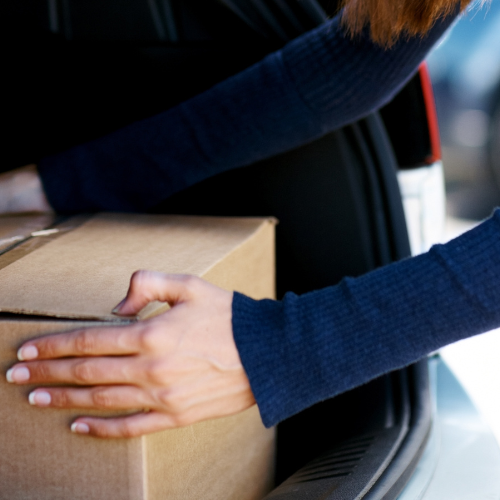 Putting a cardboard box in a trunk